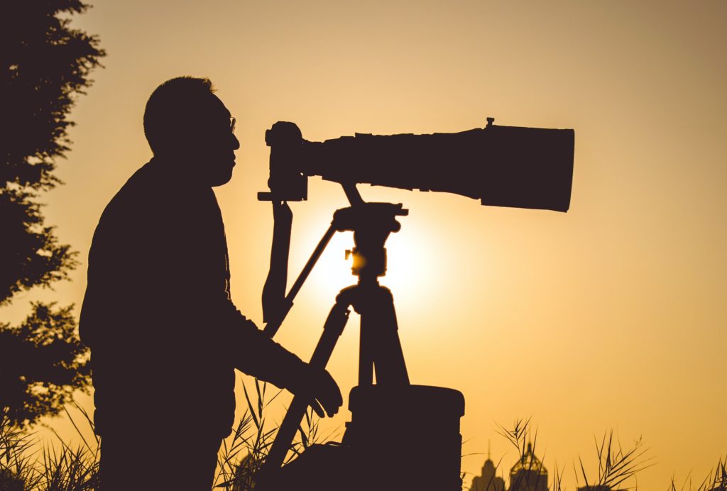 Eight Ways to Ease Anxiety and Age Well; image of a man looking into a telescope at dusk